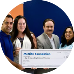 Image of four donors with a check